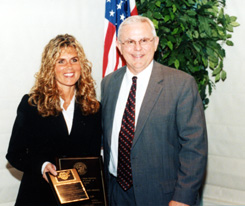 A picture of Ms. Giglia receiving her award from State Attorney Norm Wolfinger.